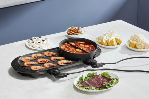 Electric grill with food on a white table
