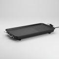 Rectangular black grill pan with handles on a white background
